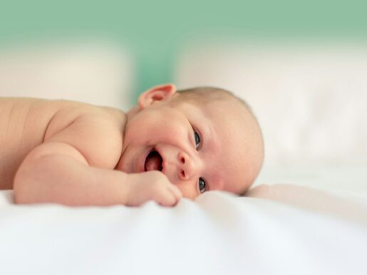 baby lying on fabric cloth