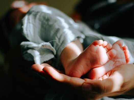person holding baby feet