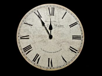 white and black analog clock at 10 10